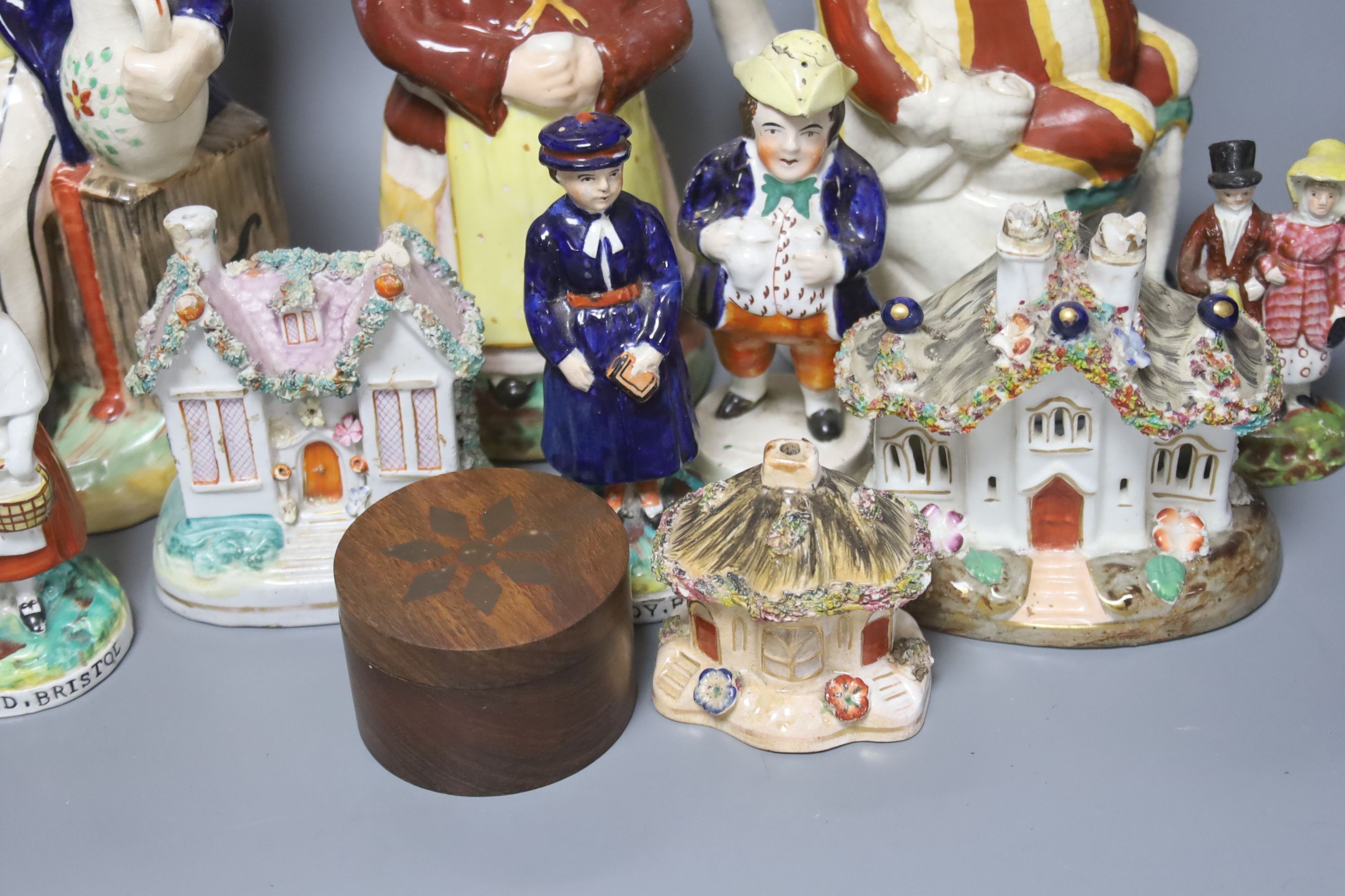A group of assorted 19th century and later Staffordshire ceramics including a Toby jug, Colston Boy and Red Maid Girl Bristol